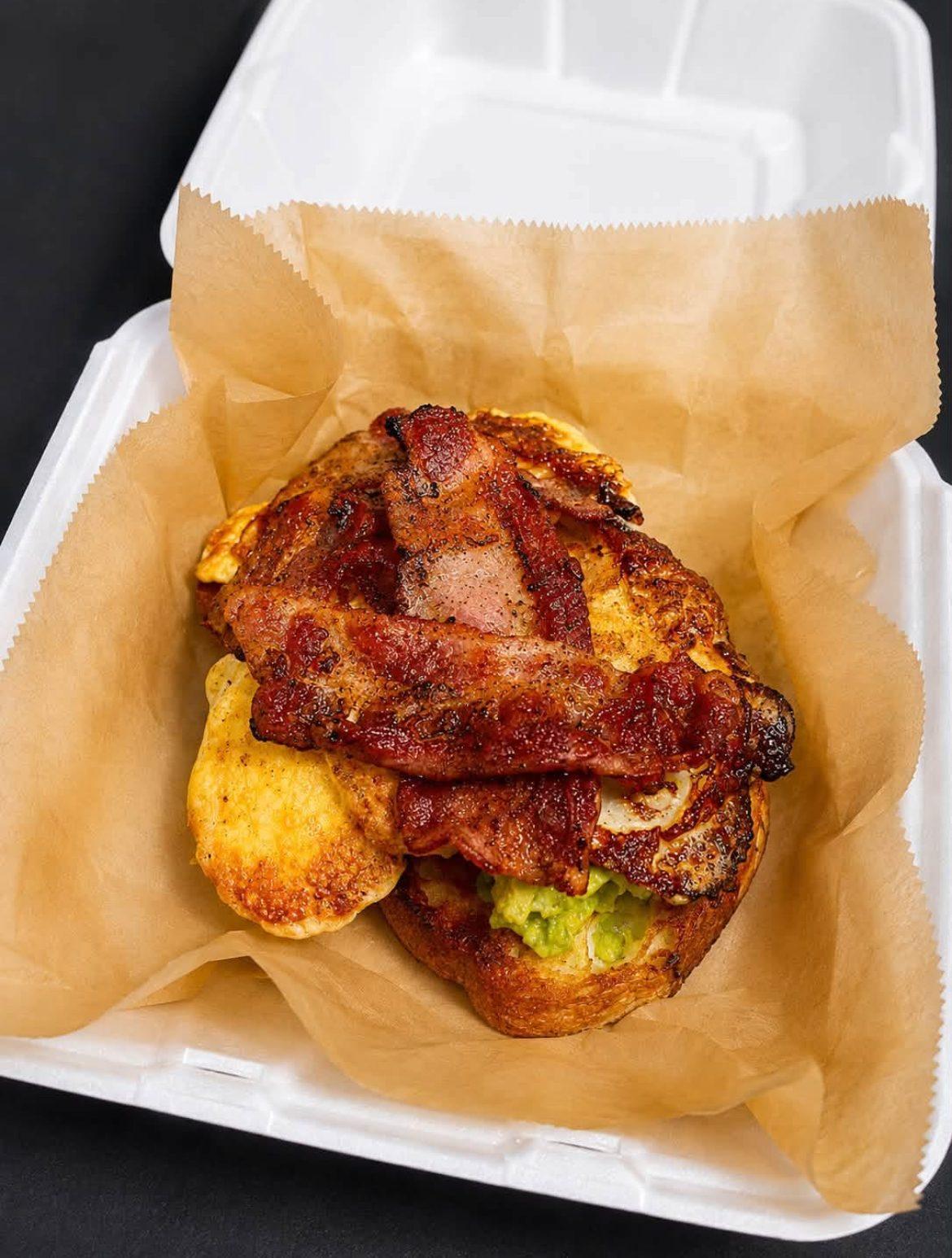 Early Enrollment — jalapeño cheddar sourdough stacked with bacon, eggs, and avocado