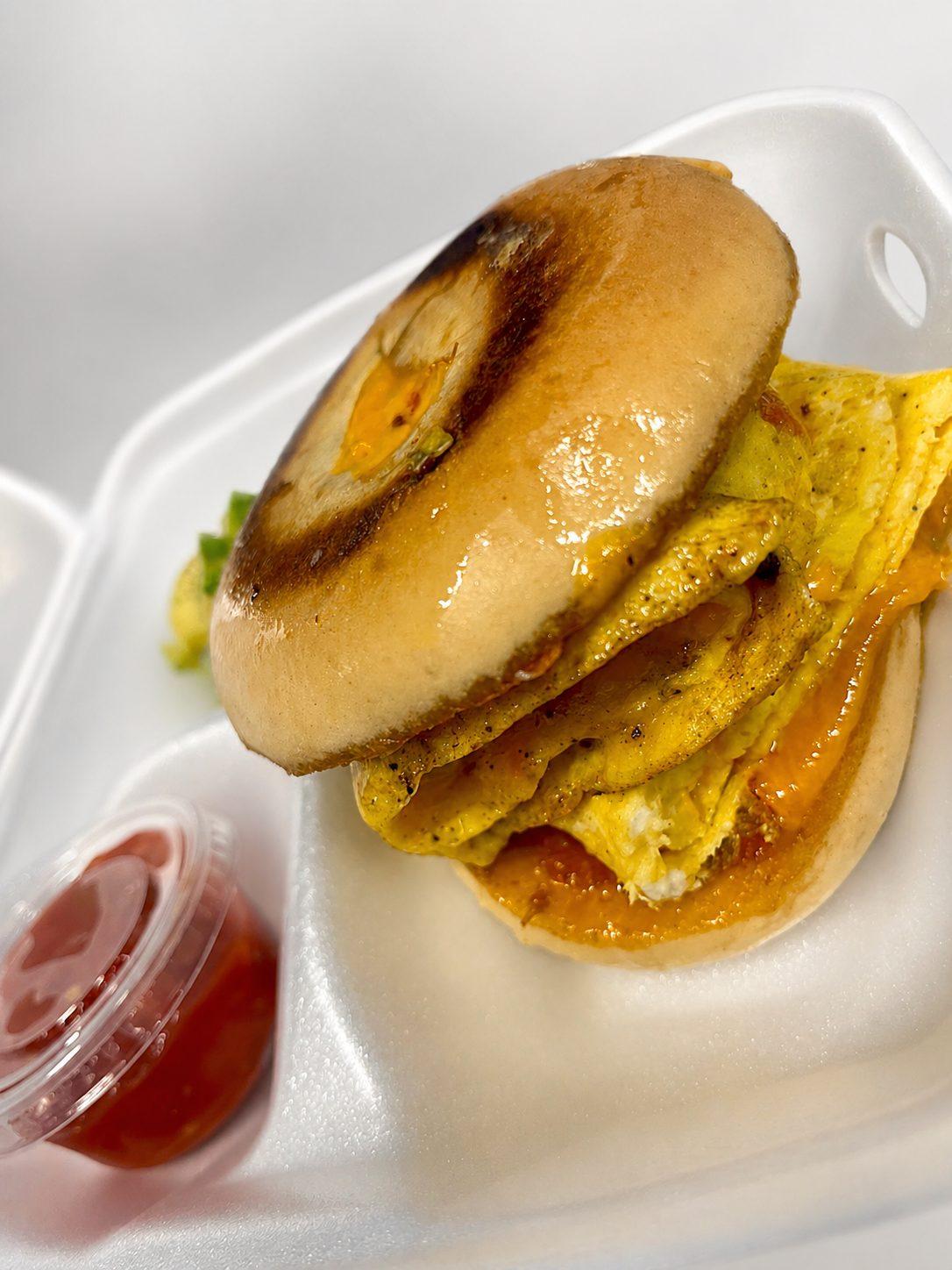 First Period Favorite — toasted bagel with bacon, egg, and cheese, with a side of jam